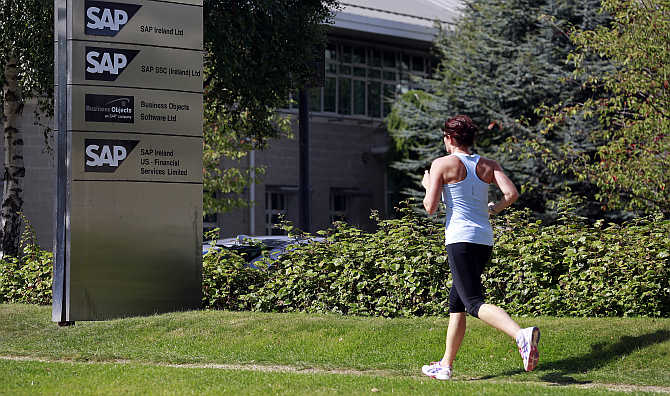 A woman jogs past the SAP offices in the CityWest complex, Dublin, Ireland.