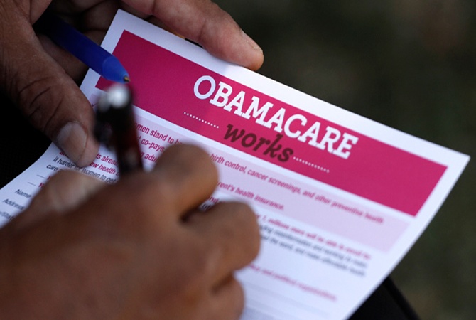 A man fills out an information card during an Affordable Care Act outreach event hosted by Planned Parenthood for the Latino community in Los Angeles, California.