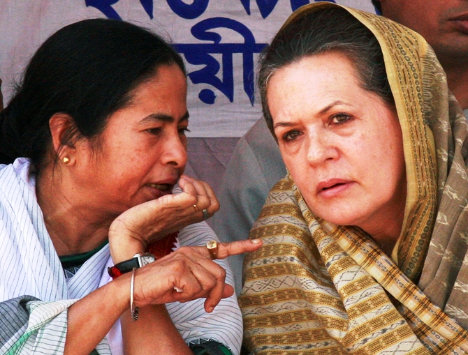 This file photograph shows chief of Congress party Sonia Gandhi (right) listening to West Bengal Chief Minister and Trinamool Congress chief Mamata Banerjee during an election campaign rally in Lalgola on April 27, 2009.