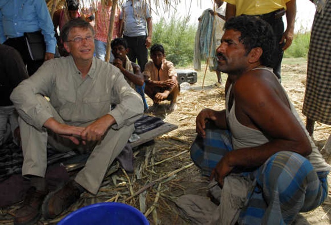 Microsoft co-founder Bill Gates interacts with a villager in Aulali village in Khagaria district, Bihar.