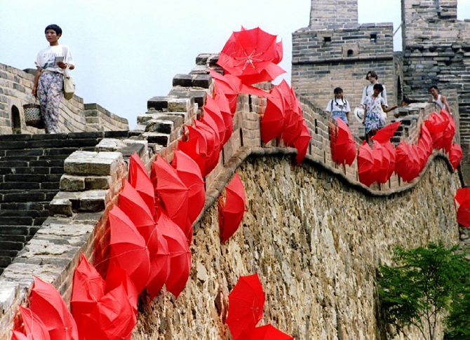 Tourists stroll on The Great Wall lined with red umbrellas at Si Ma Tai, north of Beijing.