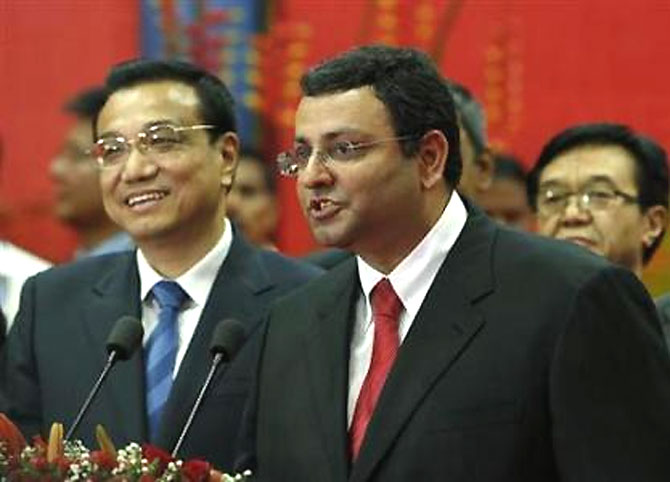 Tata Group chairman Cyrus Mistry speaks as China's Premier Li Keqiang (L) looks on at an office of software services company TCS in Mumbai on May 21, 2013.