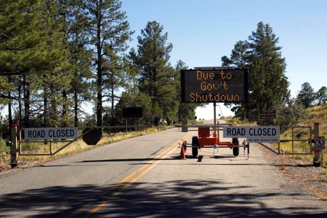 A sign at the entrance to Bandelier National Monument in New Mexico announces its closure.