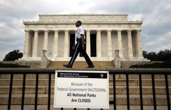 A National Parks policeman walks past a sign after the Lincoln Memorial was sealed off from visitors in Washington.