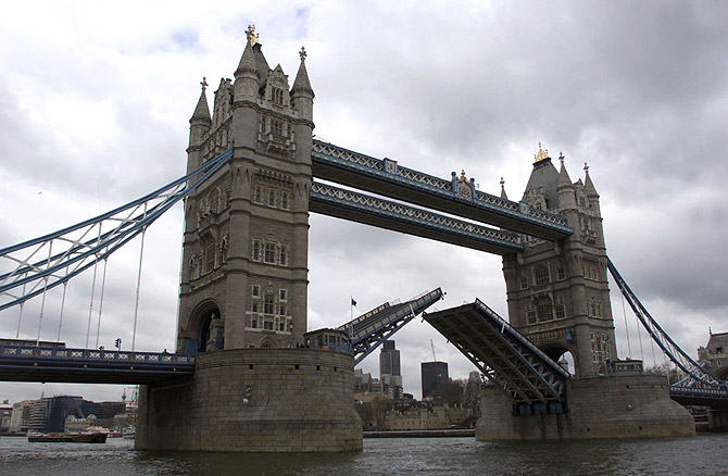 Tower Bridge closes after a tall ship has past through it.
