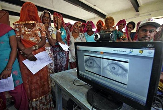 Village women stand in a queue to get themselves enrolled for the Unique Identification (UID) database system at Merta district in Rajasthan.