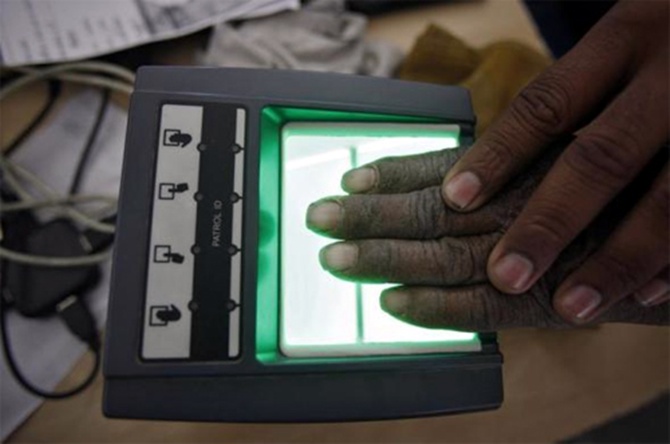 A villager goes through the process of a fingerprint scanner for the Unique Identification (UID) database system at an enrolment centre at Merta district in Rajasthan.
