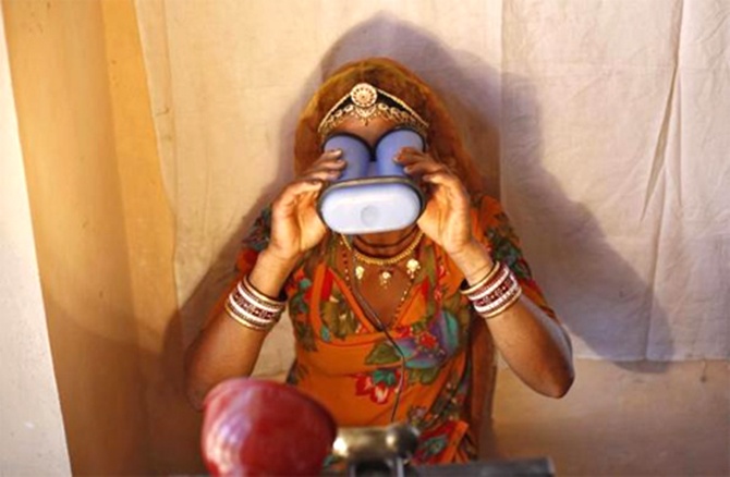 A villager goes through the process of eye scanning for Unique Identification (UID) database system at an enrolment centre at Merta district in Rajasthan.