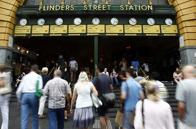 Office workers head to Flinders Street Station in central Melbourne, Australia.