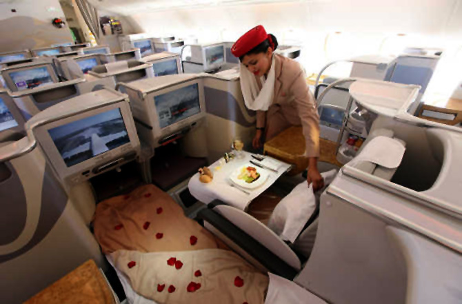 A stewardess adjusts a pillow in the business-class section of an Emirates Airbus A380.
