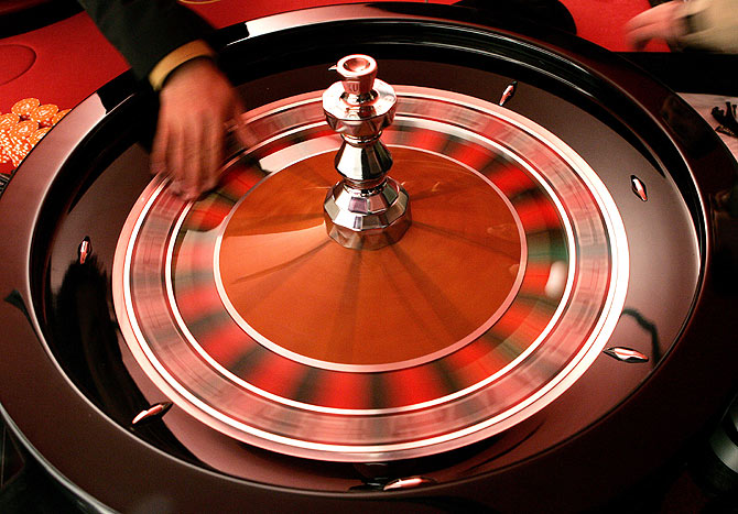 A croupier turns the roulette in a casino.