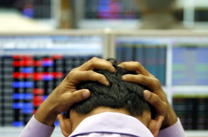 An Indian broker reacts while trading at a stock brokerage firm in Mumbai.