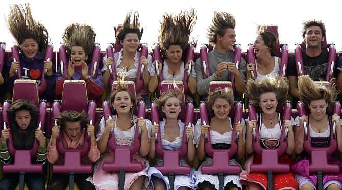 People enjoy a ride in a roller coaster at the traditional Bavarian beer festival Oktoberfest in Munich, Germany.