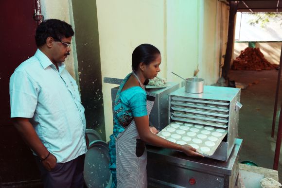 Idlis being prepared at one of the breakfast centres.