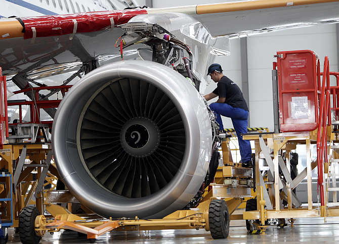 An employee installs an engine for an A320 plane at the final assembly line of Airbus factory in Tianjin municipality, China.