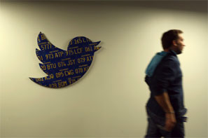 Image: An employee walks past a Twitter logo made from Californian license plates at the company's headquarters in San Francisco. Photograph: Robert Galbraith/Reuters