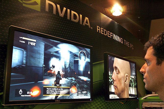 A sales man demonstrates a computer game in a display area of Nvidia Corp. during the second day of the annual Computex Taipei.