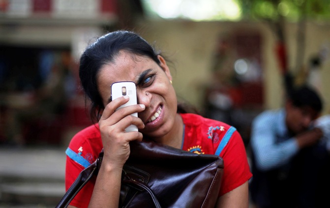 A visually impaired girl uses her mobile during a protest in New Delhi.