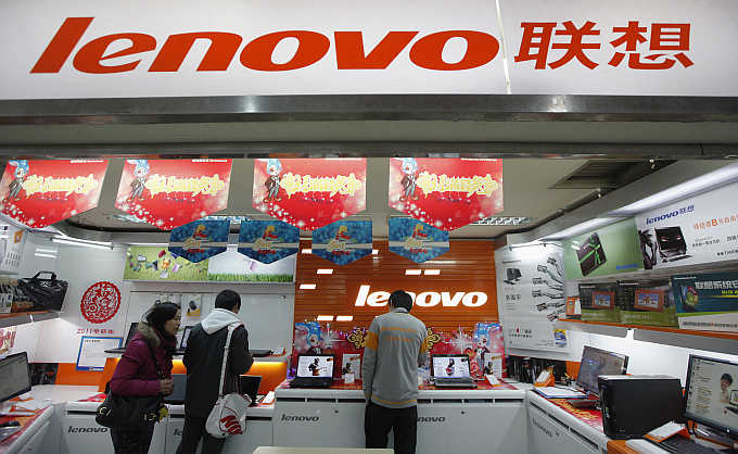 Customers talk to a salesperson at a Lenovo shop in Shanghai, China.