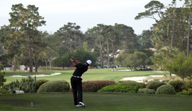 Tiger Woods hits his tee shot on the third hole at Monterey Peninsula Country Club.