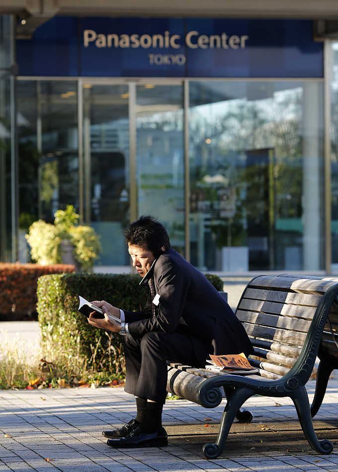 A man uses his mobile phone in front of Panasonic's showroom in Tokyo, Japan.