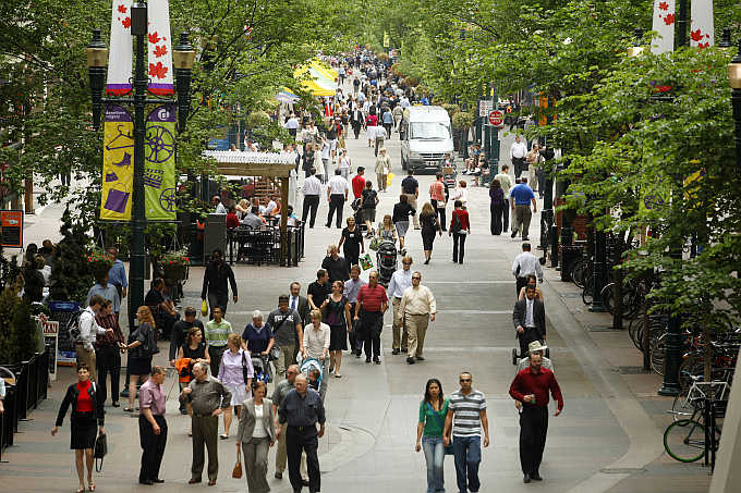 People stroll down the historical Stephen Avenue Walk in the heart of downtown Calgary, Alberta, Canada.