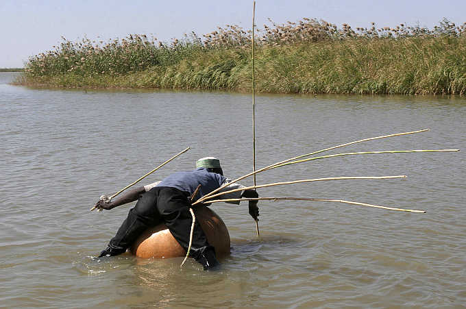 A man fishes using the traditional kalabash method in the Lake Region near the town of Bol in Chad.
