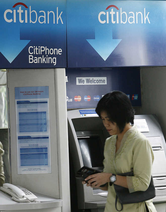 A customer leaves Citibank's automated teller machine in Jakarta, Indonesia.