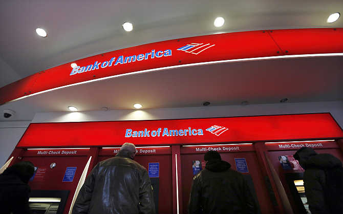 Customers use ATMs at a Bank of America centre in New York City's financial district.
