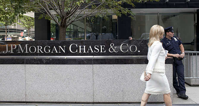 A woman walks past JPMorgan Chase's international headquarters on Park Avenue in New York City.