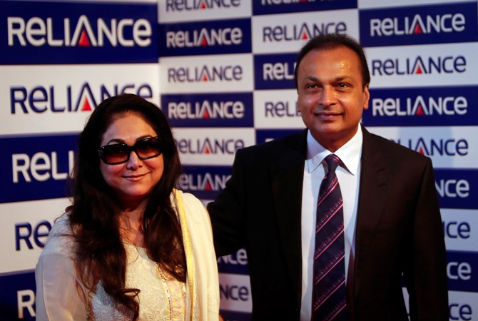 Anil Ambani, chairman of the Reliance Anil Dhirubhai Ambani Group, poses with his wife Tina Ambani for photographers before addressing the annual shareholders meeting in Mumbai August 27, 2013.