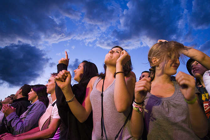 Festival-goers watch the performance of singer Amy Macdonald at the Paleo music festival in Nyon, Switzerland.