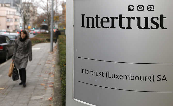 A woman walks past the logo of Intertrust company in Luxembourg.