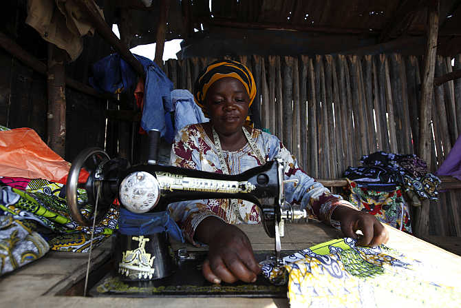 A woman sews clothes on a sewing machine in Gatumba, outside Bujumbura, Burundi.