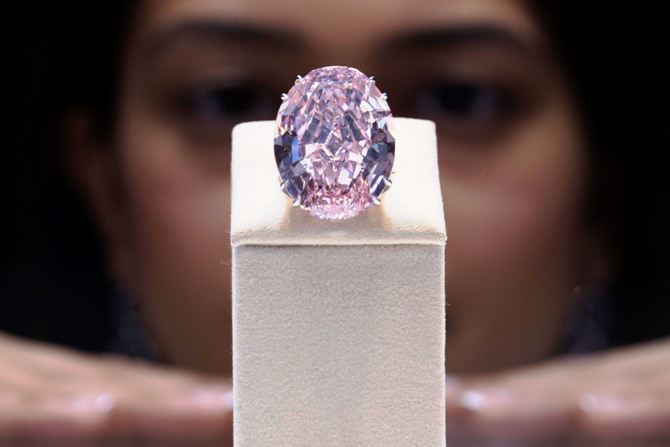 A model poses with the Pink Star diamond during a press preview at Sotheby's in Hong Kong.