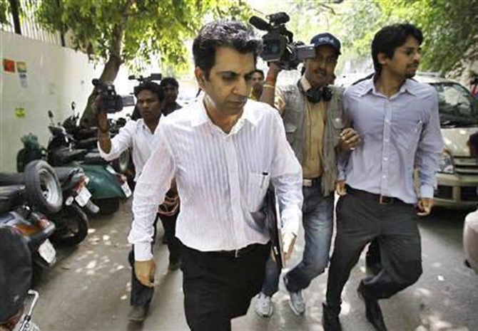 Managing Director of Telenor's India partner Unitech, Sanjay Chandra (C) leaves a court in New Delhi.