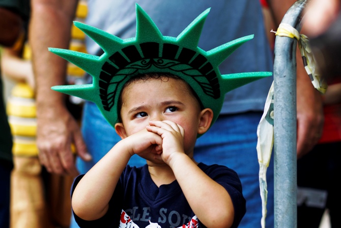 A child attends a ceremony to reopen the Statue of Liberty and Liberty Island to the public in New York July 4, 2013. 