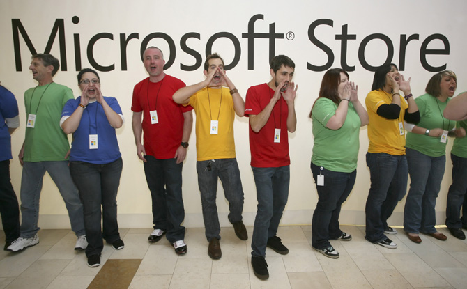 Employees of the new Microsoft Store cheer to a waiting crowd of more than 2,000 people before opening the store in Bellevue, Washington.