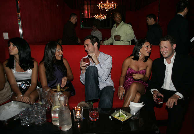 Clubbers take a break from dancing in the Red Room at the Pure nightclub inside Caesars Palace hotel-casino in Las Vegas, Nevada, United States.