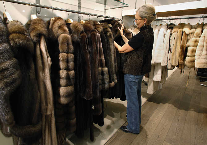 Saleswoman Annette Bourbon arranges a display of mink and sable coats at a fur salon in downtown Copenhagen, Denmark.