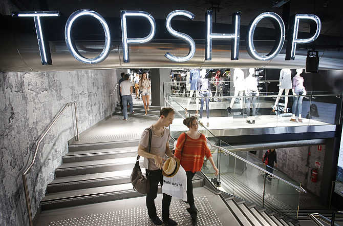Shoppers exit a Topshop store in Sydney, Australia.