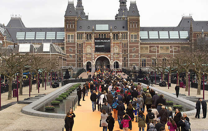 Visitors enter the Rijksmuseum in Amsterdam, the Netherlands.