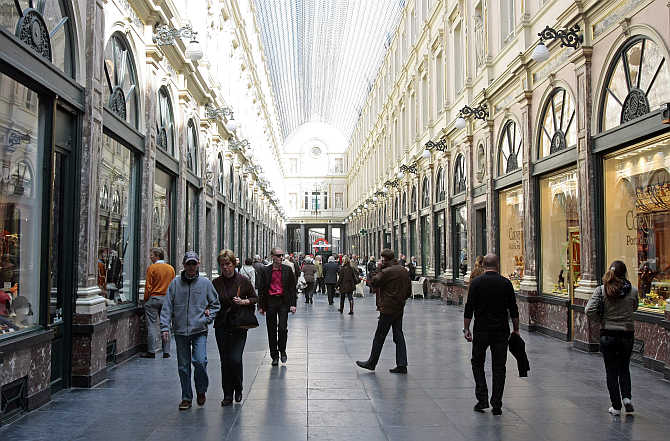 Tourists walk in Brussels' Royal Galleries of Saint Hubert, Belgium.