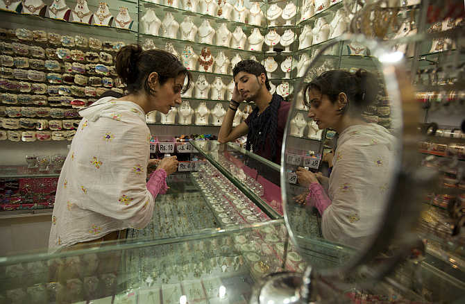 A woman buys jewellery in Islamabad, Pakistan.