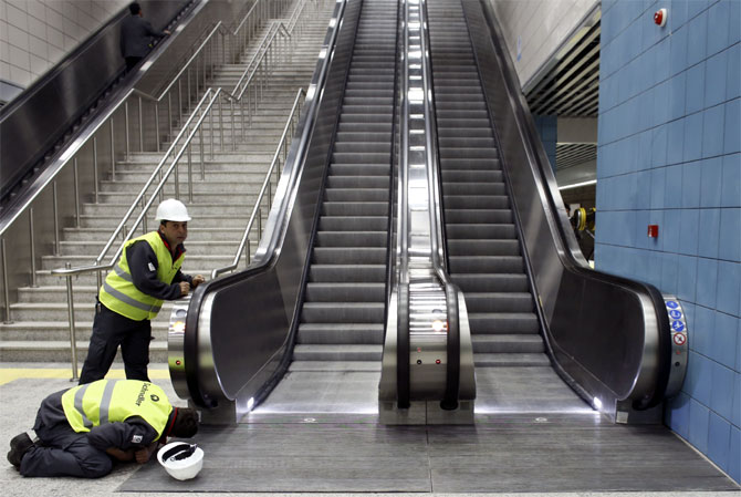 Engineers perform the last checks on escalators of a station of Marmaray, a subway which links Europe with Asia some 60 metres below the Bosphorus Strait.