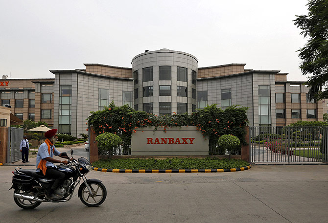 A man rides a motorcycle in front of the office of Ranbaxy Laboratories at Gurgaon
