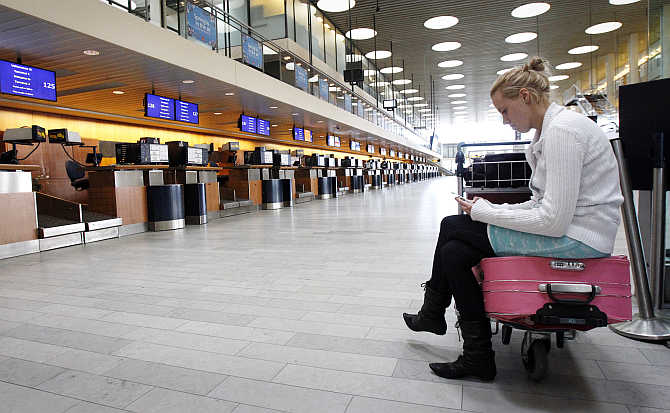 Christina Klarskov Pedersen waits for her flight to Spain after volcanic ash from an Icelandic volcano closed Copenhagen's Kastrup Airport, Denmark.