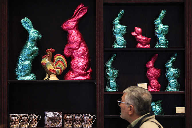 A man watches chocolate bunnies for Easter at a shop of Fassbender & Rausch chocolate maker at Berlin's Gendarmenmarkt square, Germany.