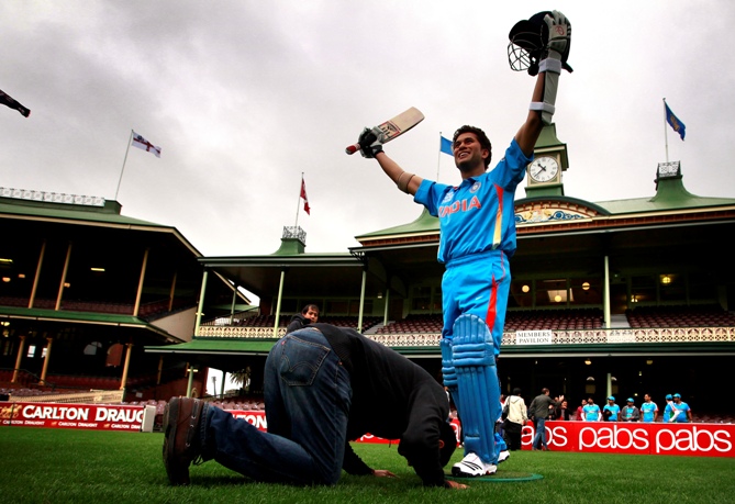 An Indian cricket supporter kneels in front of a wax figure of Sachin Tendulkar during a promotional event at the Sydney Cricket Ground April 20, 2013.