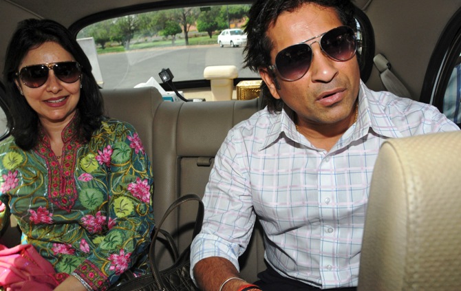 Sachin Tendulkar, along with his wife Anjali, arrives at the Indian parliament to be sworn in as a member of parliament in New Delhi.